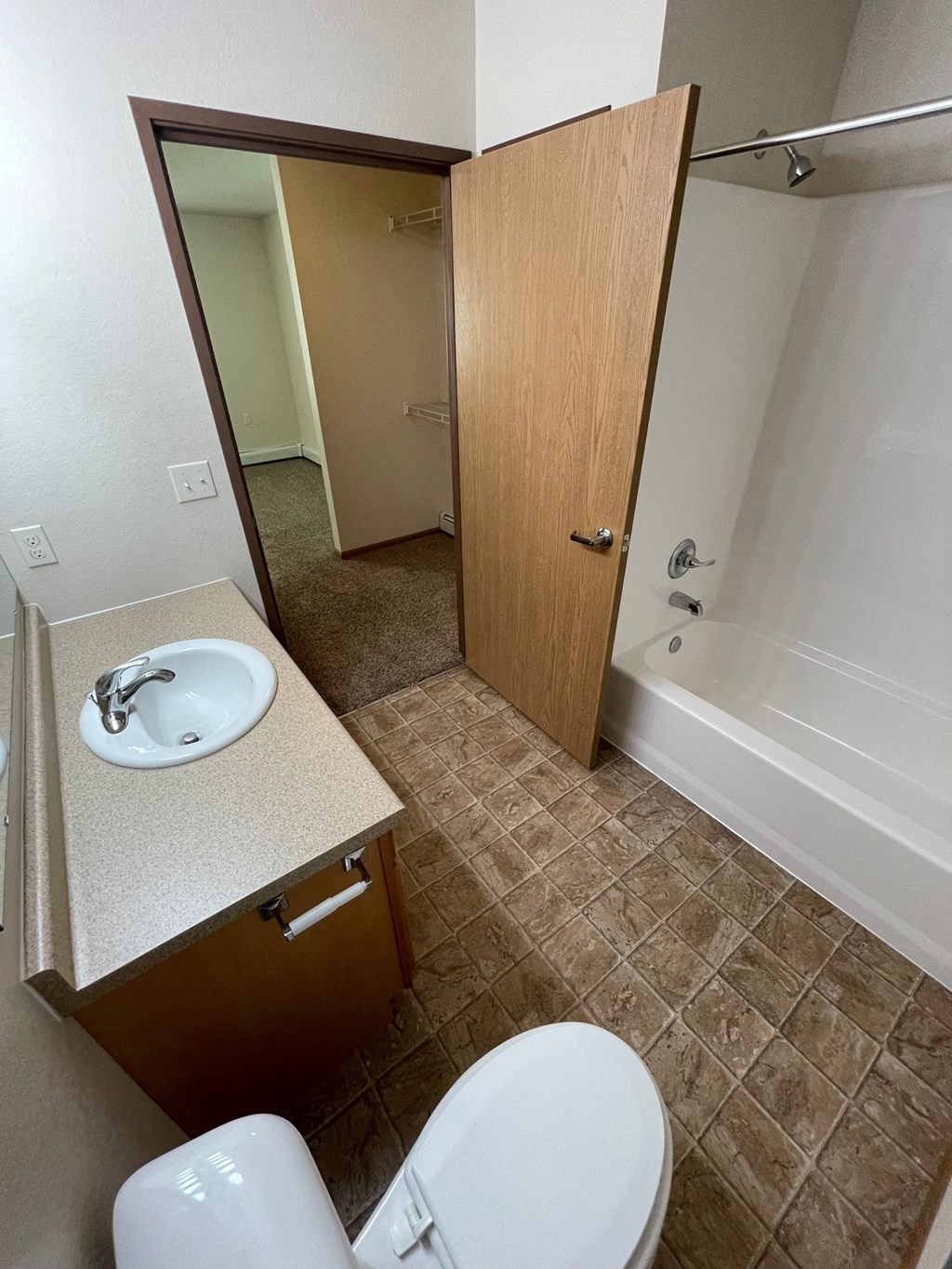 a bathroom with a toilet and a sink and a bath tub
