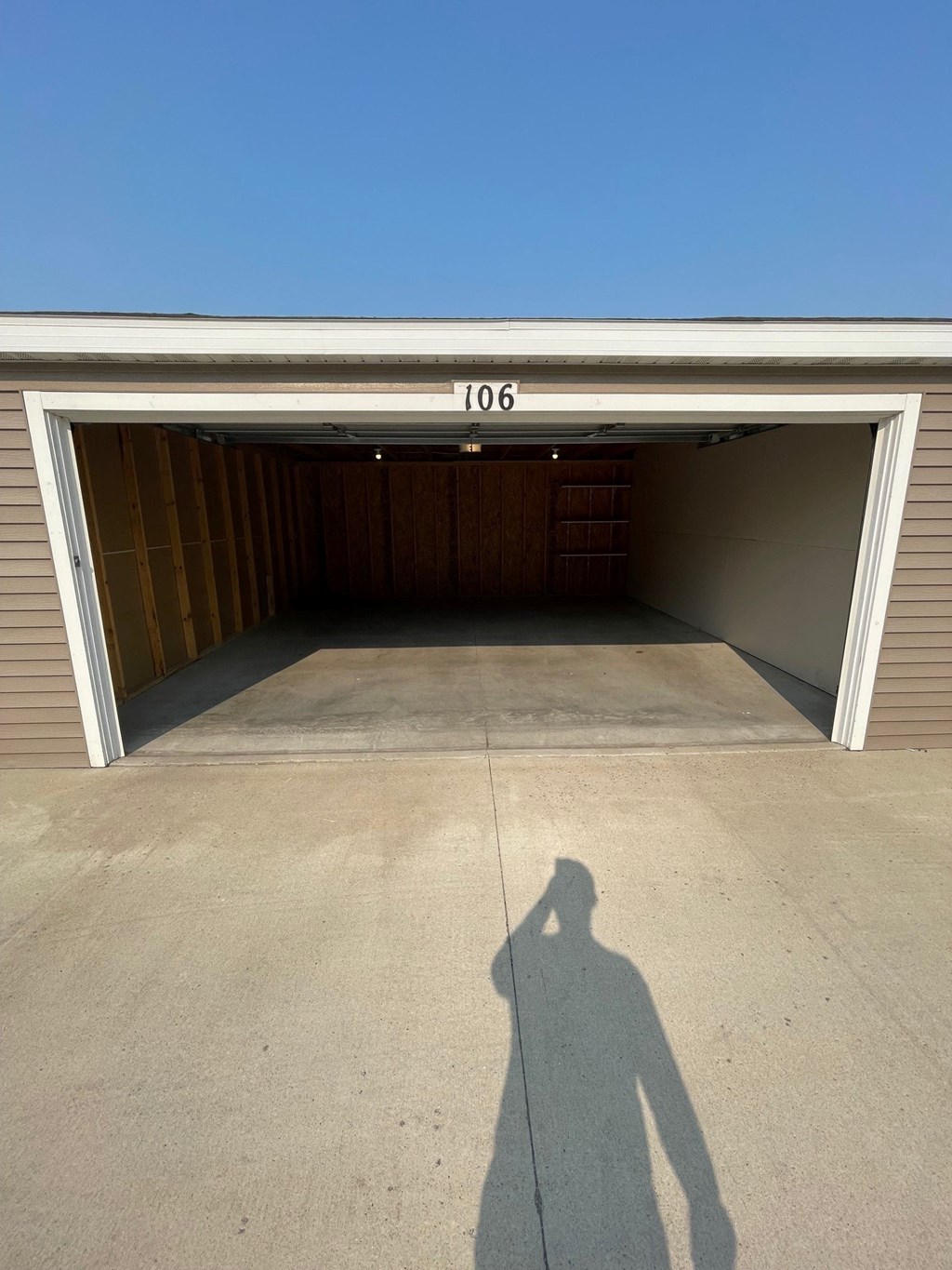 a shadow of a person standing in front of a garage door