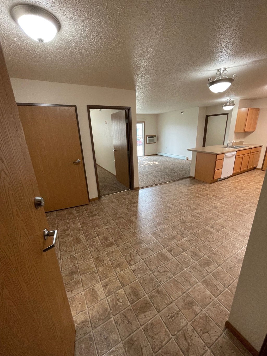 an empty living room and kitchen in a house