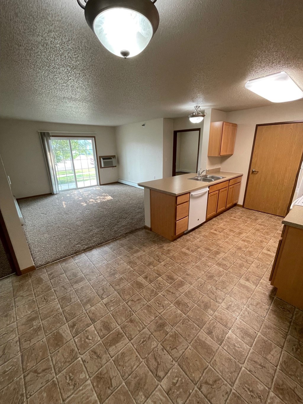 an empty kitchen and living room in a house