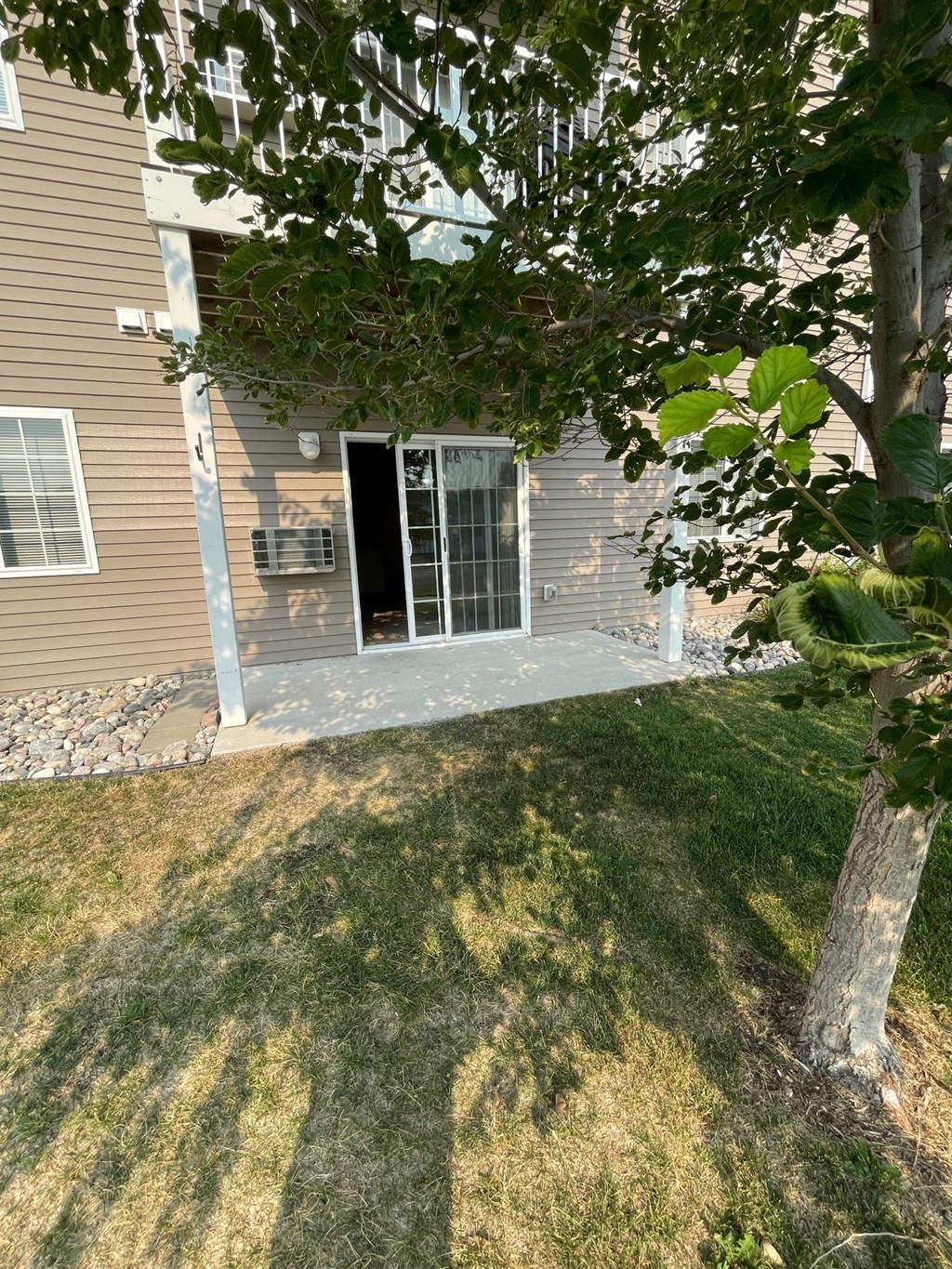 a view of the back of a house with the door open