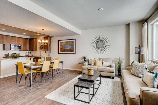 a living room and kitchen with a table and chairs