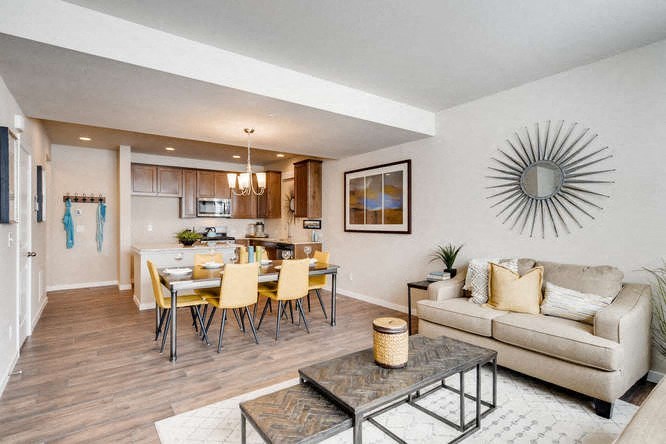 a living room and kitchen with a table and chairs