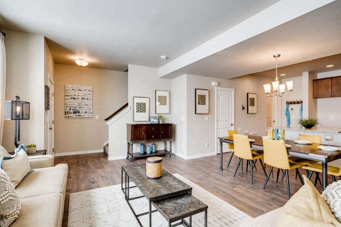 a living room and dining room with a table and chairs