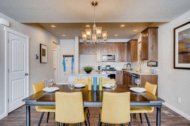 a kitchen and dining room with a table and chairs