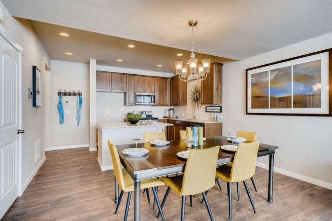 a kitchen and dining room with a table and chairs