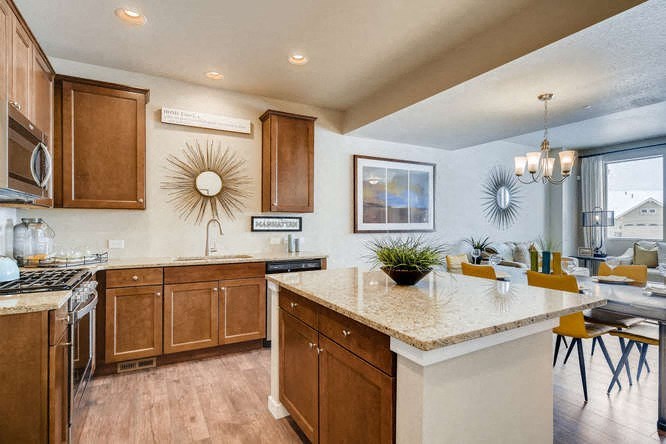 a kitchen with an island and a table with chairs