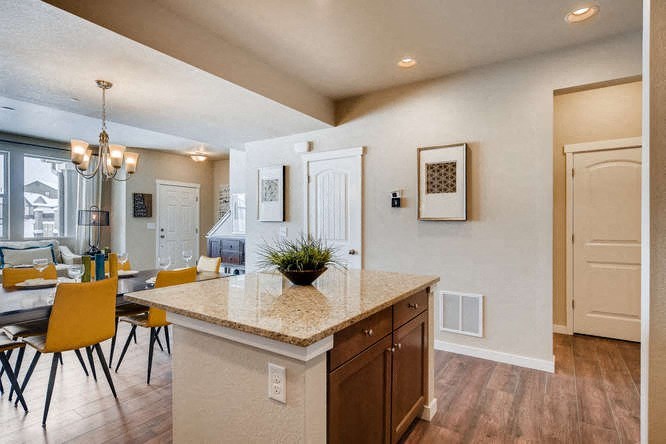 a kitchen and dining room with a table and chairs