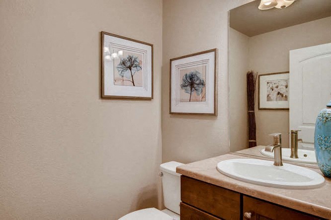 a bathroom with a sink and a toilet and a mirror