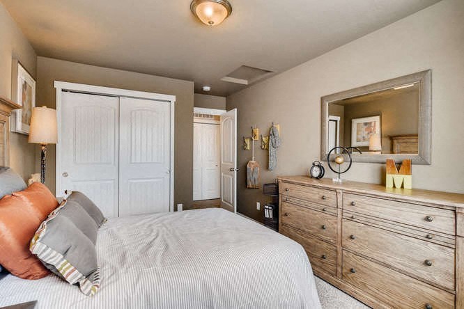 a bedroom with a large bed and a mirror