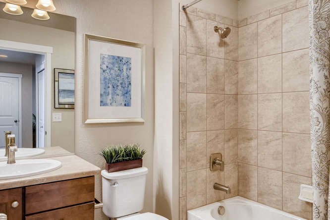 a bathroom with a shower and a sink and a toilet