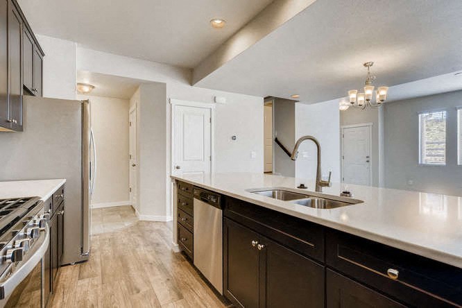 a kitchen with a sink and a refrigerator