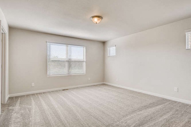 an empty room with white walls and a window