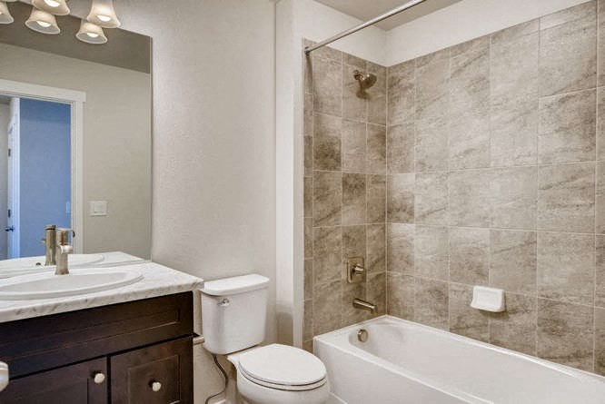 a bathroom with a tub toilet and a sink