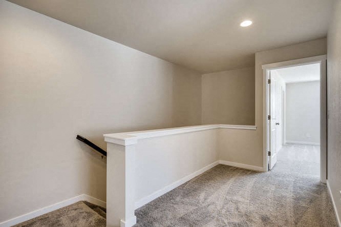 a empty room with a white wall and a door