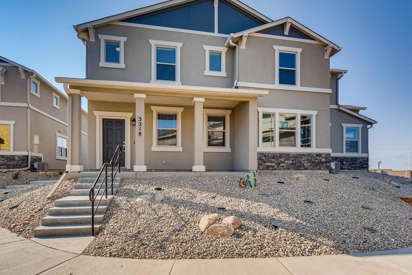 a new house with a gravel driveway and steps