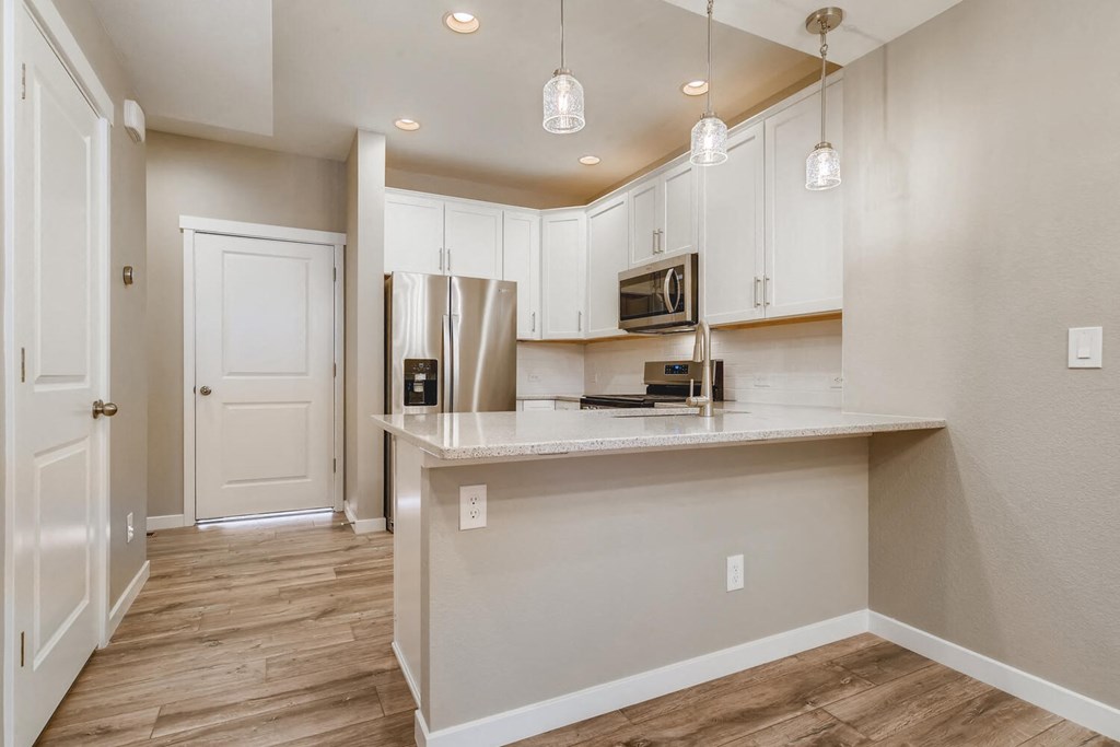 a kitchen with white cabinets and a counter top