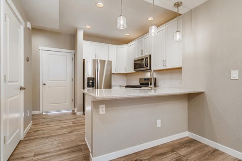 a kitchen with white cabinets and a counter top