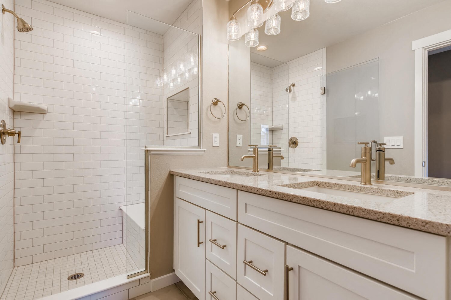 a white bathroom with two sinks and a shower