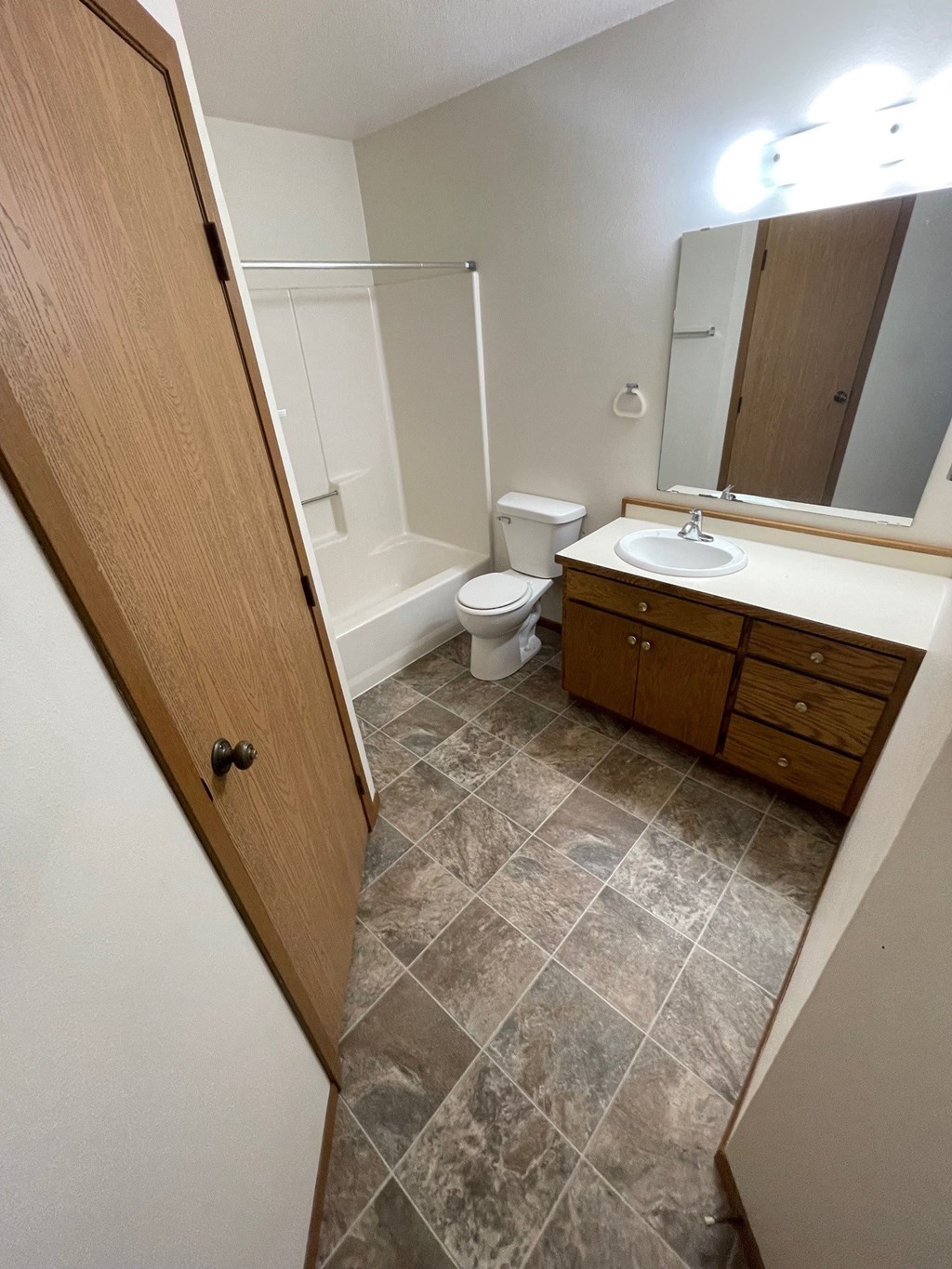 a bathroom with a sink toilet and a mirror