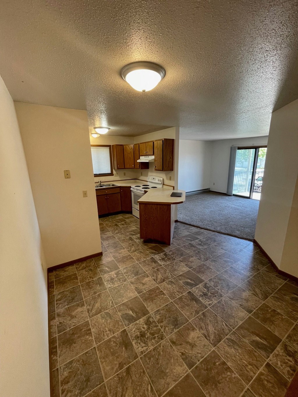 an empty kitchen and living room in an empty house