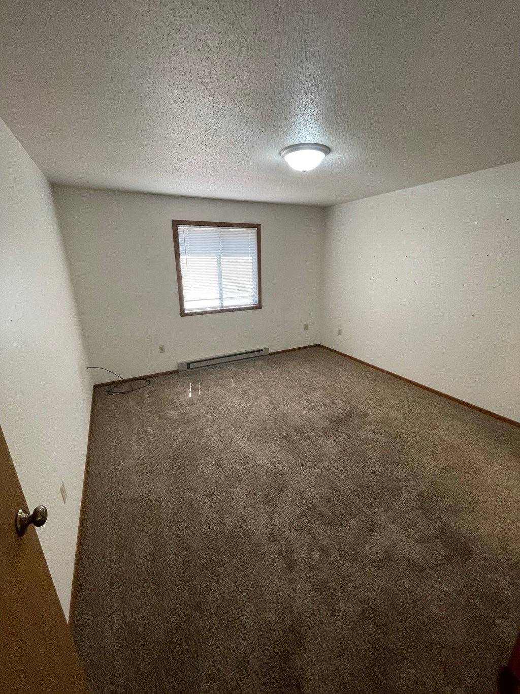 the living room of an empty house with a window