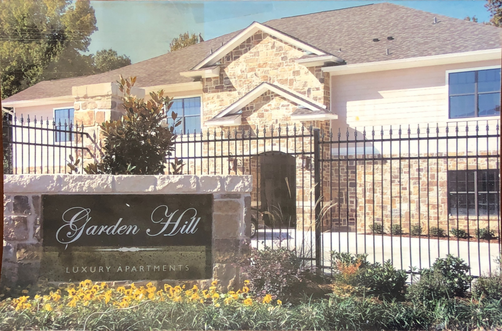a home with a sign in front of a fence