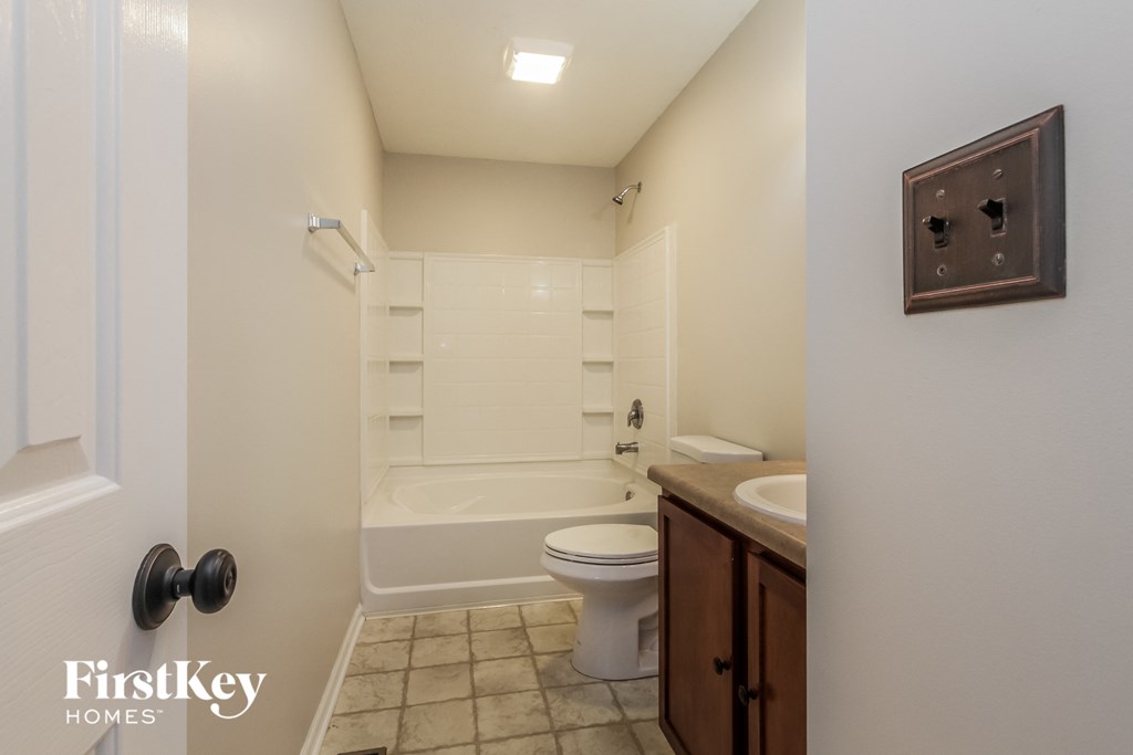 a bathroom with a toilet and a sink and a bath tub