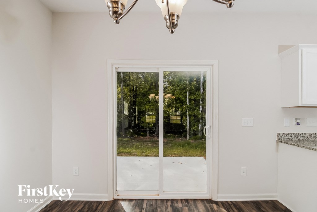 a kitchen with glass doors and a view of the woods