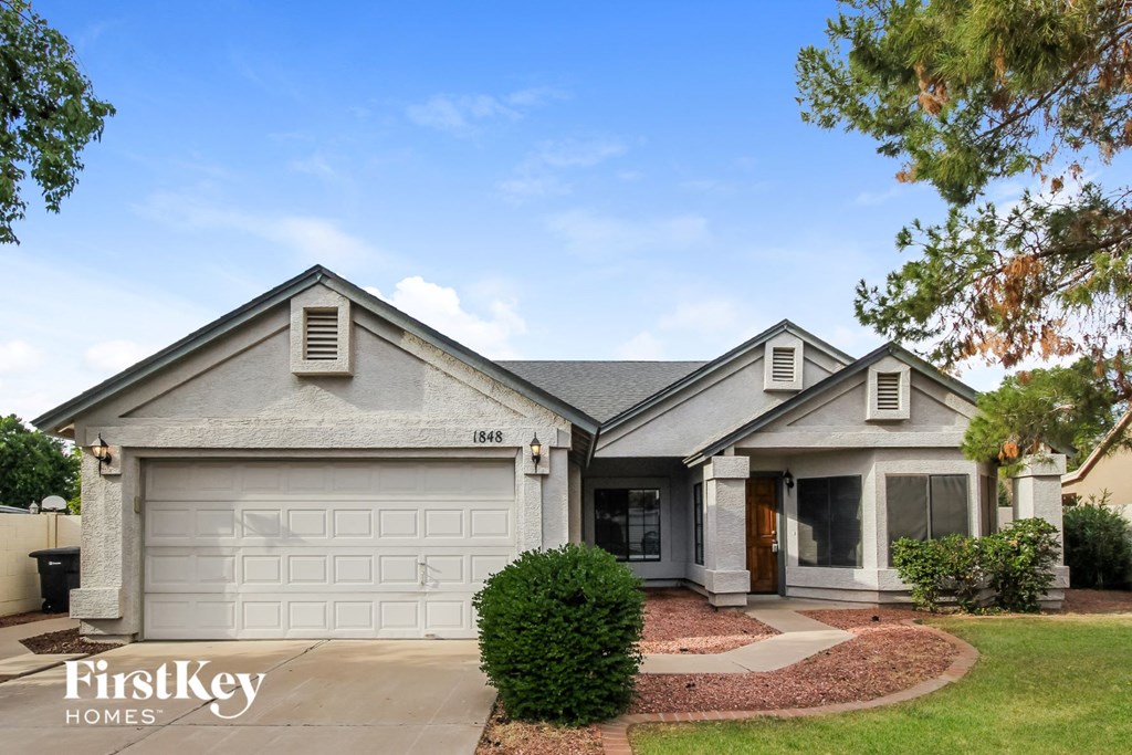 a home with a white garage door and a driveway
