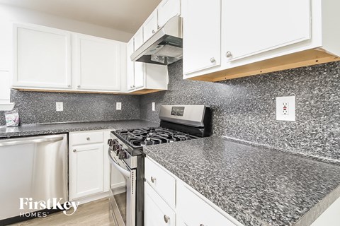 A kitchen with a stove top oven and a microwave.