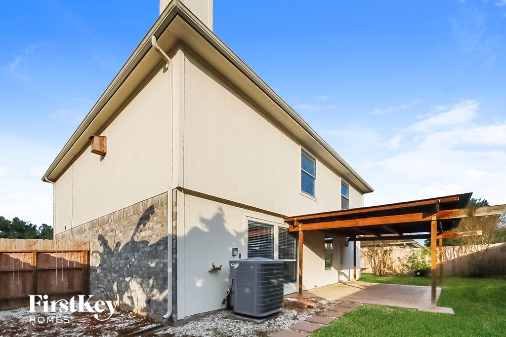 A house with a brown roof and a white wall with a mural on it.