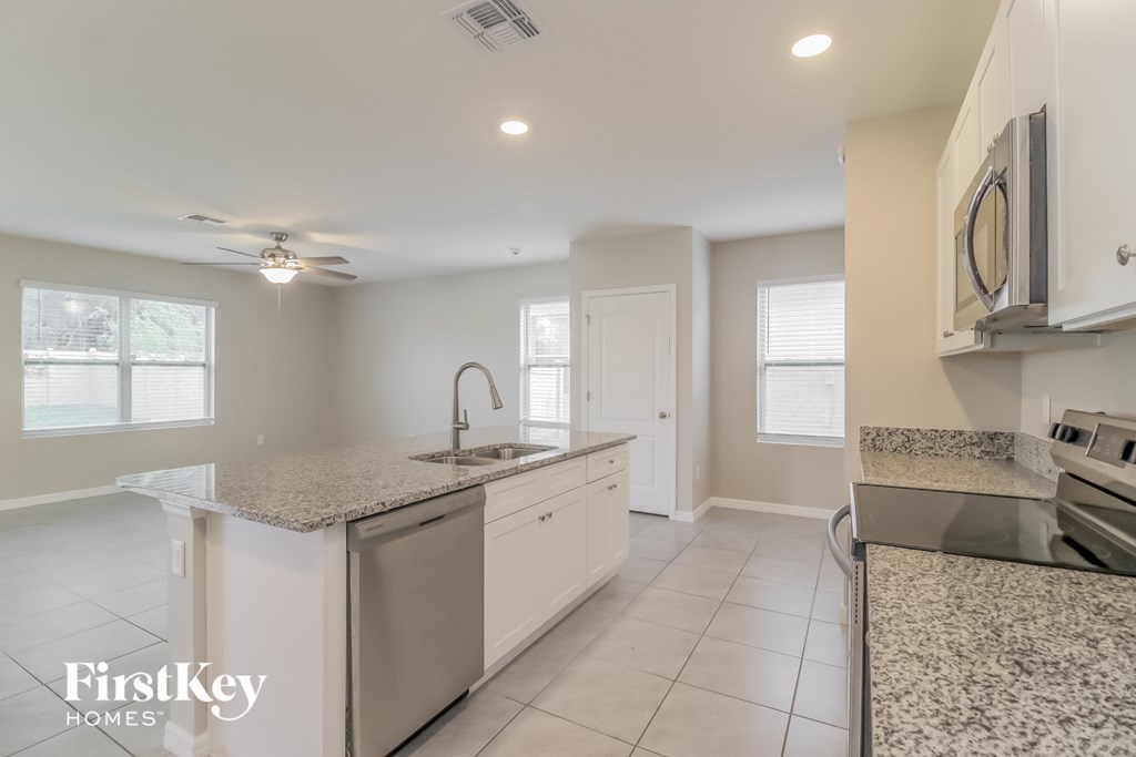 A kitchen with granite countertops and stainless steel appliances.