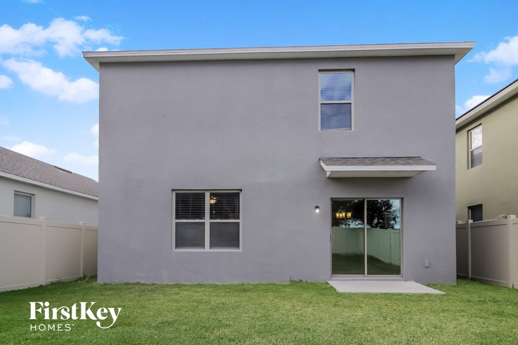 A grey house with a glass door and a window.