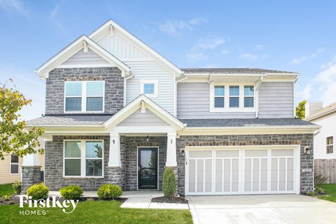a blue and white house with a white garage door