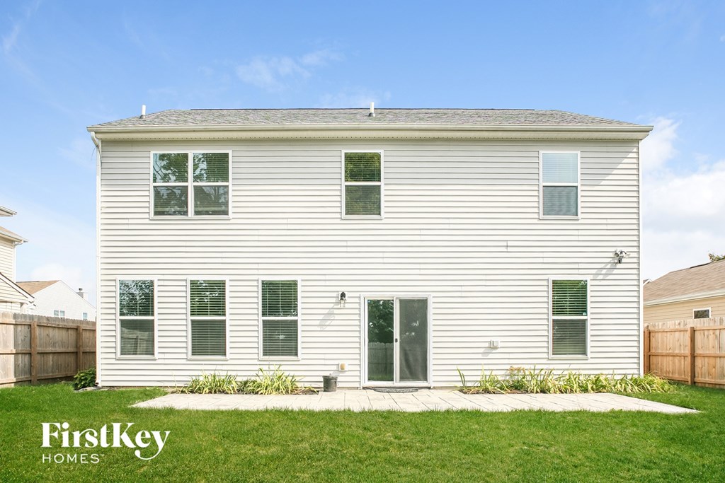 a white house with white siding and green grass