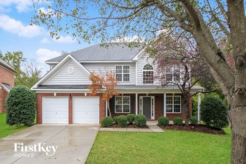A house with a tree in front of it.