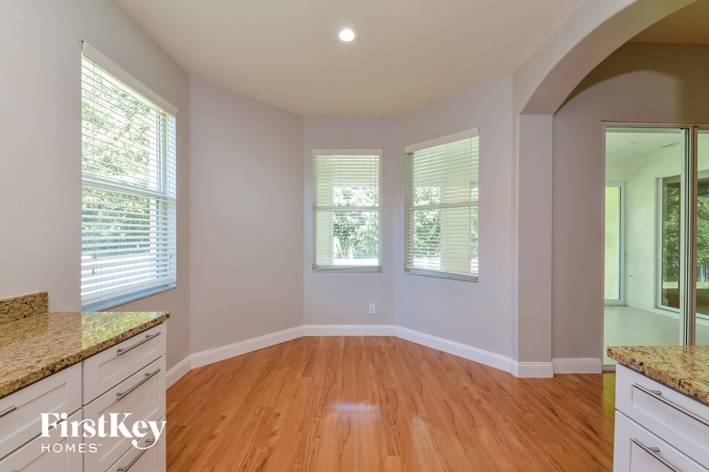 A room with wooden floors and a FirstKey Homes logo.