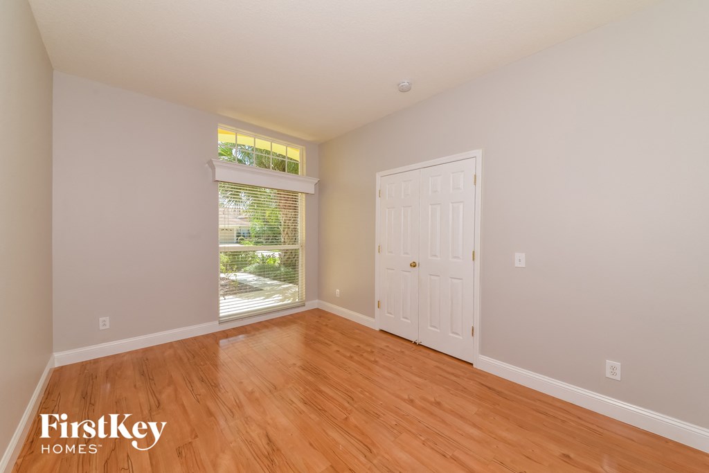 A room with wooden floors and a white door.