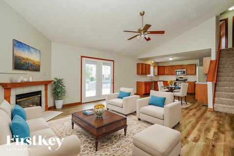 A living room with a fireplace and a painting on the wall.