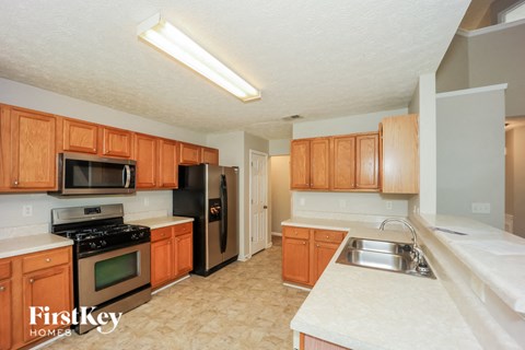 a kitchen with wooden cabinets and stainless steel appliances