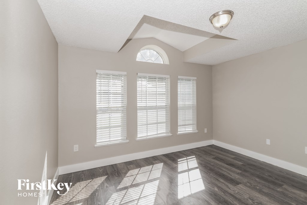 the living room with hardwood flooring and a large window