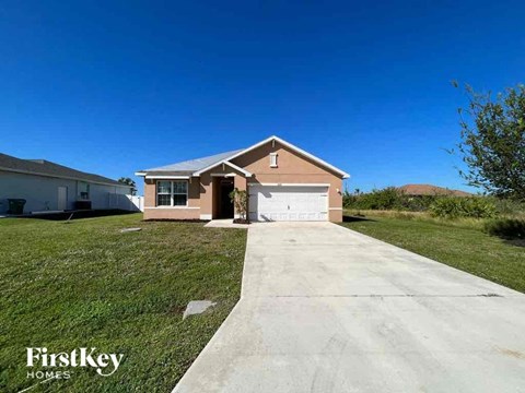 A house with a driveway in front of it is for sale.