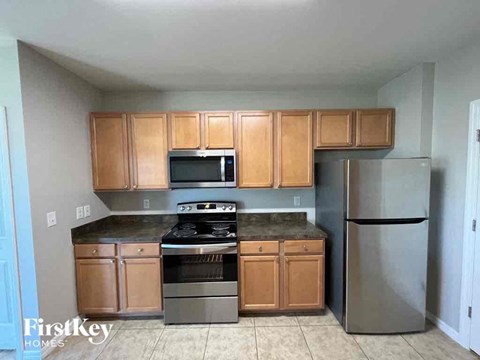 A kitchen with wooden cabinets and stainless steel appliances.