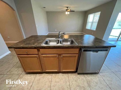 A kitchen with a sink and a dishwasher.