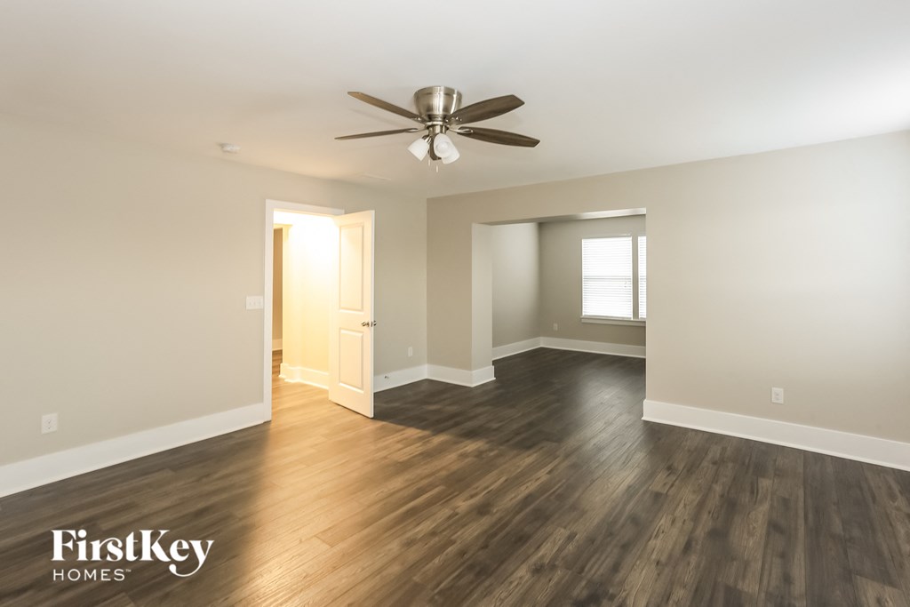 a living room with hardwood floors and a ceiling fan