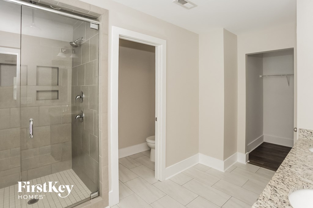 a bathroom with a shower and a toilet in it