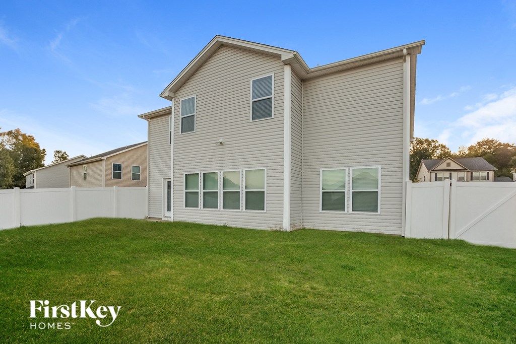 the exterior of a house with a yard in front of it