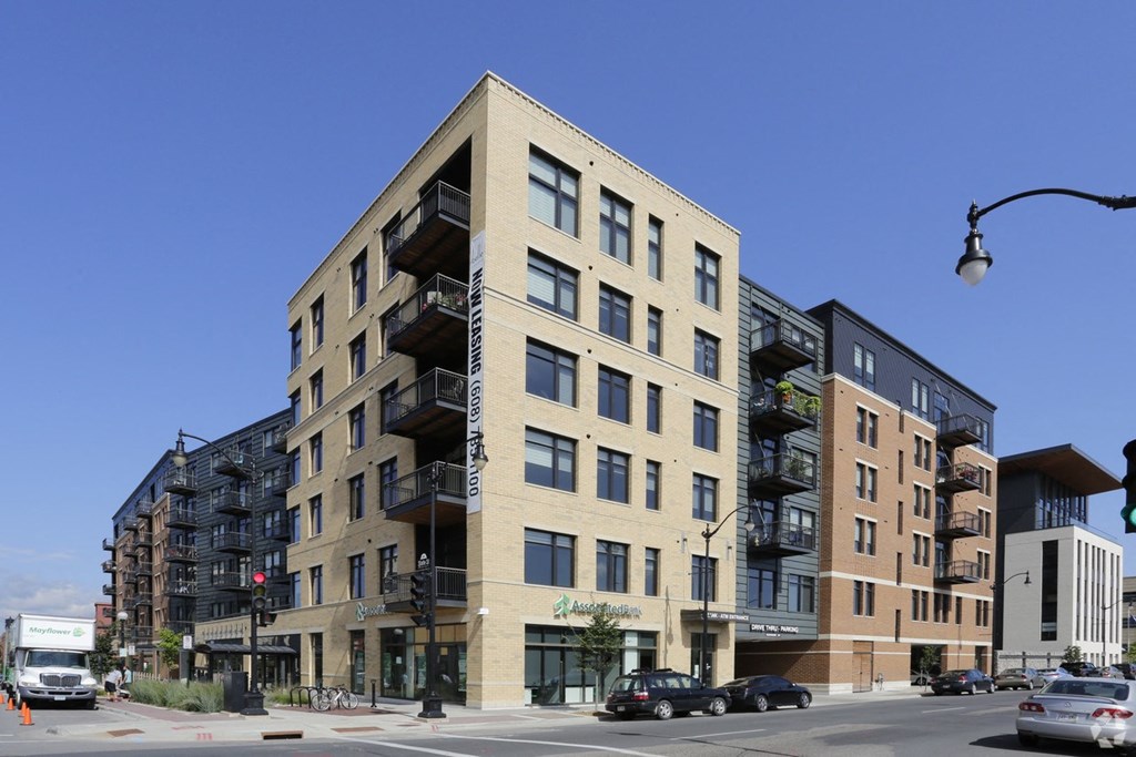 a building on the corner of a city street with cars