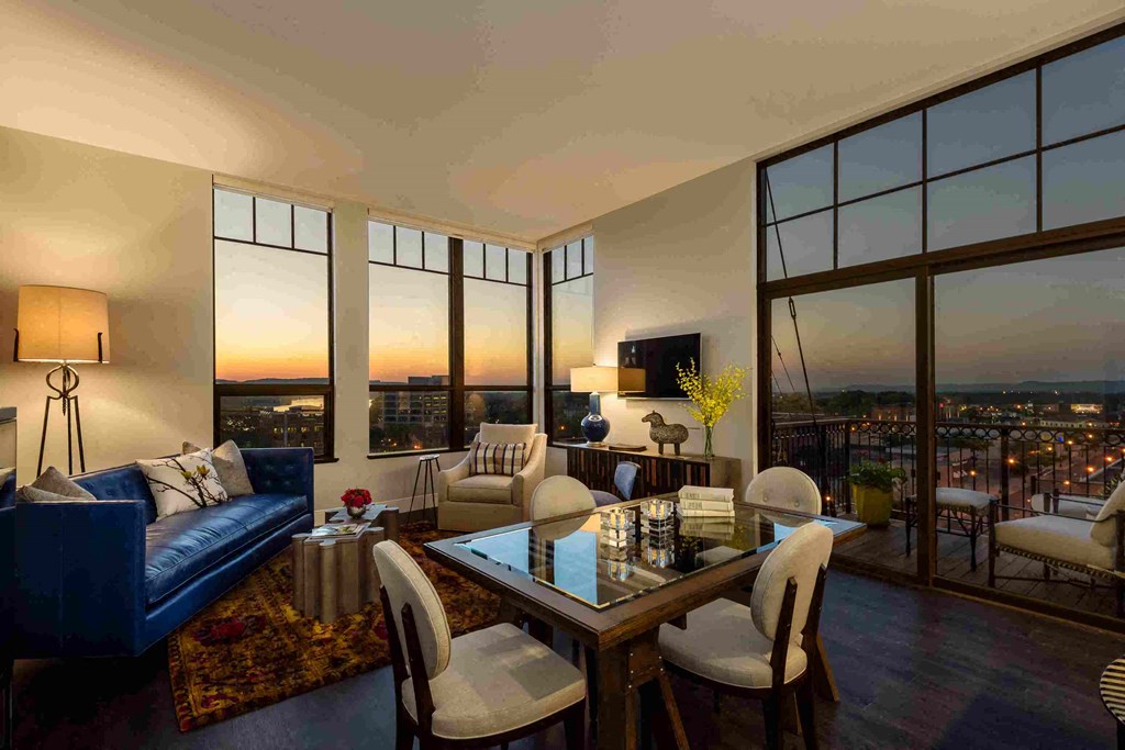 a living room with a view of the city from the window